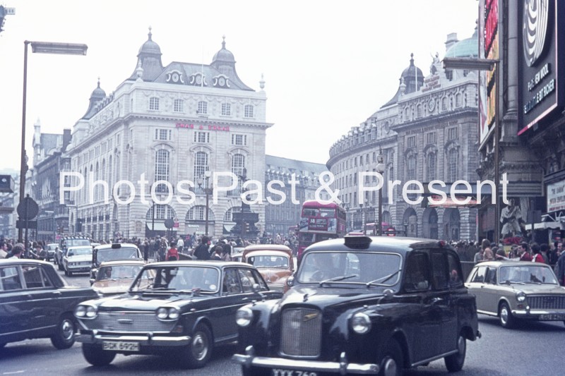 Austin & London Taxi Cab at Picadilly Circus 1970